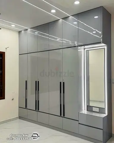 Modern grey built-in wardrobe with mirror and drawers