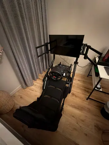 Racing simulator rig with steering wheel, pedals and monitor mount