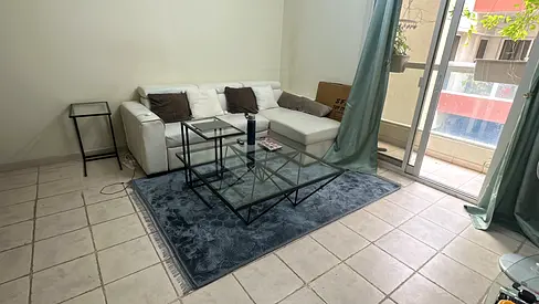 glass coffee table and modern blue rug