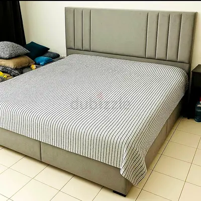 Grey upholstered bed with padded headboard - good condition