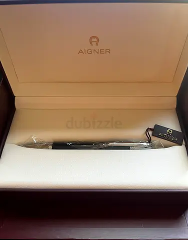 Aigner classic black pen with original box (unused) comes with a bracelet, and cuff links.