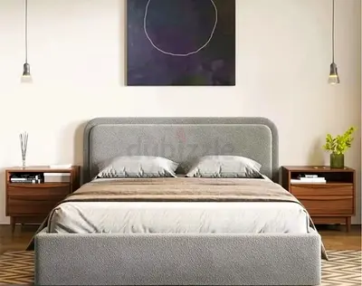 My gray linen-upholstered bed frame with rounded rectangular headboard