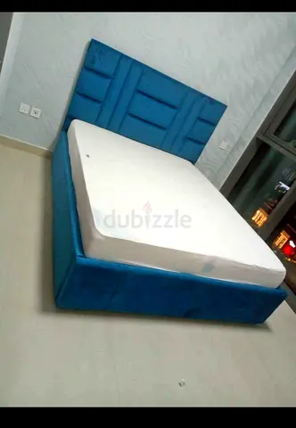 My blue upholstered bed frame with manual Storege