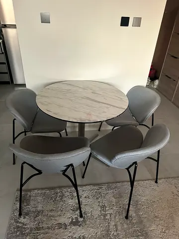 Round marble-effect dining table with 4 grey chairs