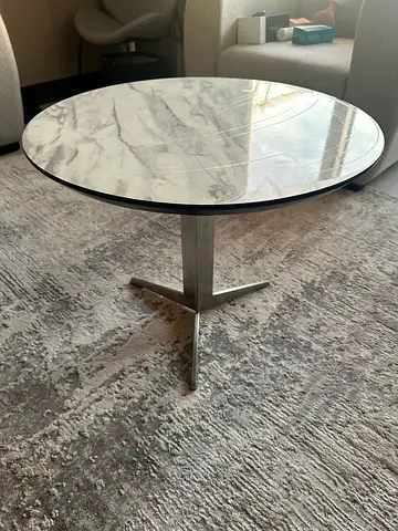 Round marble-top side table with metal pedestal base