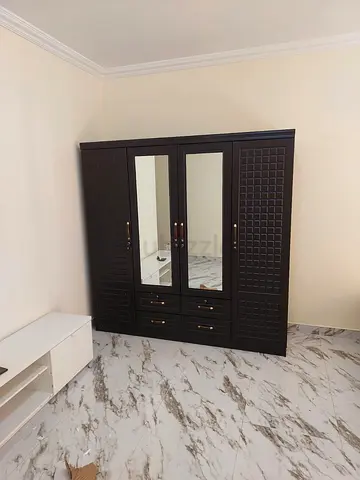 My dark wood 4-door wardrobe with mirrored doors and drawers