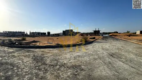 Prime townhouse plot on a street and alley in Al Zahiyah, Ajman. Strategic location with double exemption, price includes registration fees.