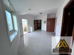 Studio apartment for annual rent in Al Rashidiya 3, Ajman, behind Grand Mall. Balcony, central air c