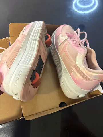 Pink rolling sneakers with heel wheels