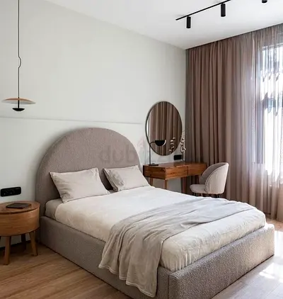 My beige upholstered bed frame with rounded headboard