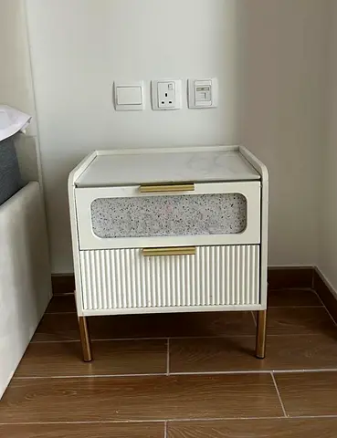 White nightstand with marble top and gold legs