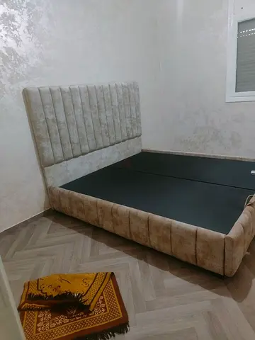 My beige upholstered bed frame with tall channel headboard