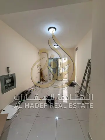 Two-bedroom apartment with a living room, free parking, and a balcony in the Al Taawun area, next to W Wilson Hospital.