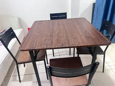 Used 4-seater dining table with wooden top and metal chairs