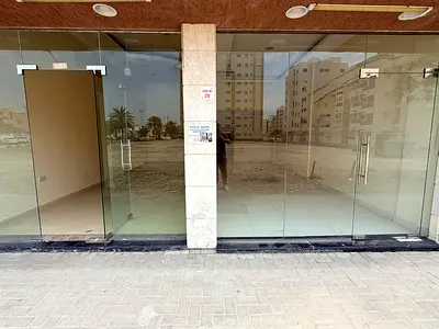 65 sqm shop in Al Butina, modern complex on main road, suitable for various businesses, rent AED 35,000 with 6 cheques.
