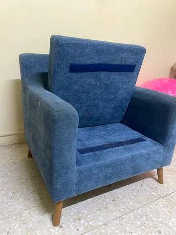 Blue fabric armchair with wooden legs — gently used
