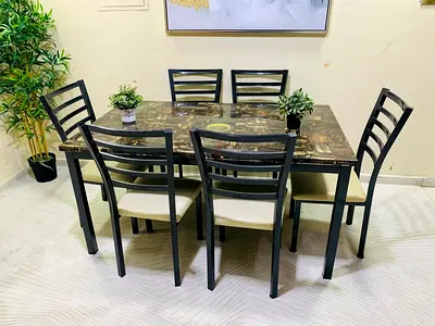 6-seater dining table set with marble-effect top and cream cushioned chairs