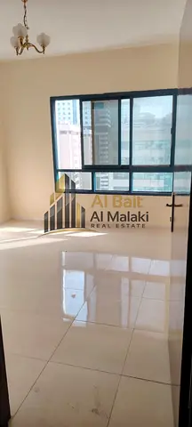Three-bedroom apartment with a living room for annual rent in Al Majaz 3, prime location and excellent condition.