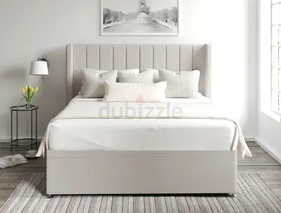 Beige upholstered bed with padded vertical-channel headboard (used)