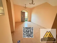 A spacious apartment with a balcony offering an open view. Located in a vibrant area near Al Hikma S