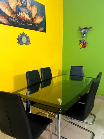 Glass dining table with 6 black chairs