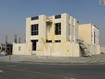 Villa for sale on a corner lot with two street frontages, including registration and ownership fees, opposite Azha Residential Complex and close to al