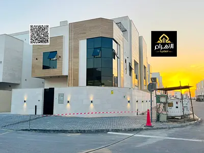 Villa for sale | Villa on two streets | In Al Helio 2, Ajman | High-quality designs and finishes | Glass stone facade | Price includes registration an