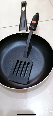 Brand new non-stick frying pan with spatula
