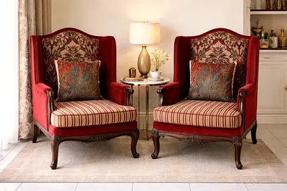 Pair of vintage red wingback armchairs with carved wooden legs