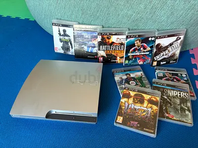 Silver PS3 Slim console with 9 PS3 games