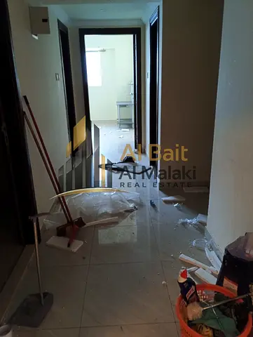 Spacious 3-bedroom apartment with a living room and a separate laundry room in a prime location in Al Majaz 2.