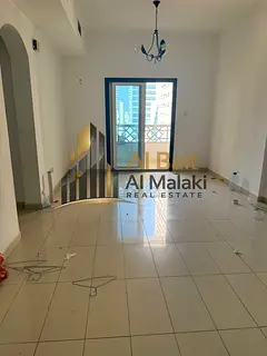 A room and a lounge with a balcony in Al Qasba, a large area, an open view and facilities in payment