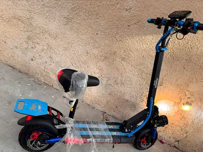 Blue electric scooter with seat .only one month used new one