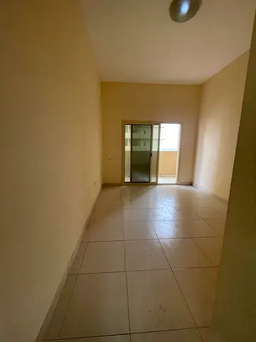 One bedroom and living room in Tower Lills, Emirates City, directly on Sheikh Mohammed Bin Zayed Road, with free gym, swimming pool, and parking