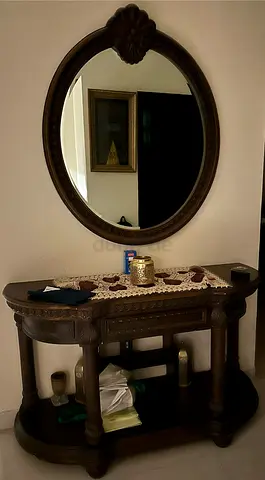 Carved wooden console table with matching oval mirror