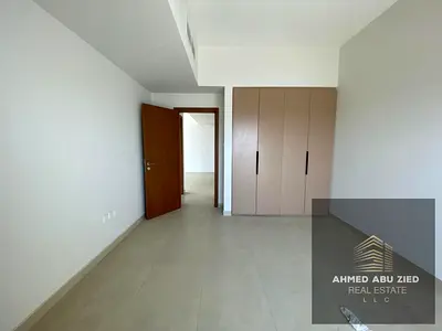 2BR apt in Emirates City | 2 master beds | 3 baths | Open balcony | Gym & pool | Free parking | Wardrobes | Near services