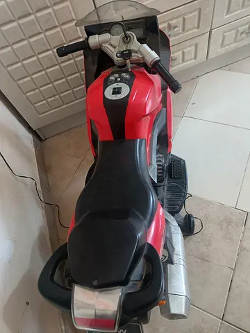 My red electric ride-on motorcycle for kids — used, charger included