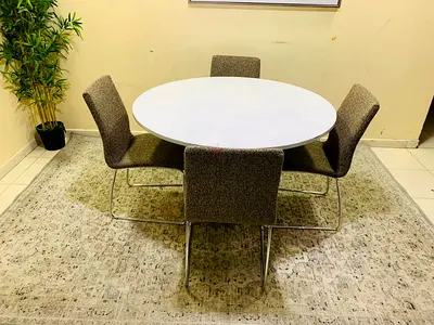 My round dining set — white table with 4 upholstered chairs
