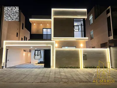Luxury villa for sale with two floors and a roof, central air conditioning, and a spacious yard, near Sheikh Mohammed Bin Zayed Road, with freehold