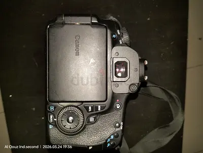 Used Canon DSLR camera body with strap — works, minor scratches