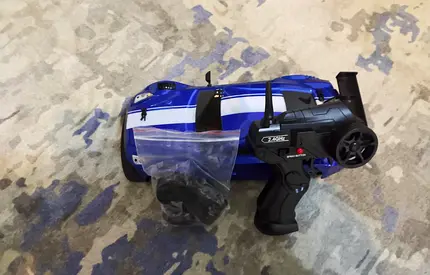 RC remote control racing car (blue) with controller and spare parts