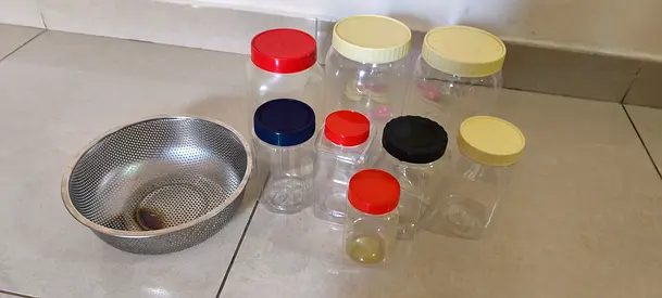 My assorted plastic kitchen storage jars with lids + stainless steel colander