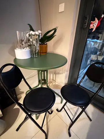 ALL IN PICTURE. Fireplace  Green bistro bar table with 2 black counter stools