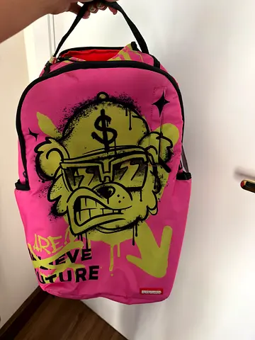 Pink cartoon graphic backpack — used, good condition
