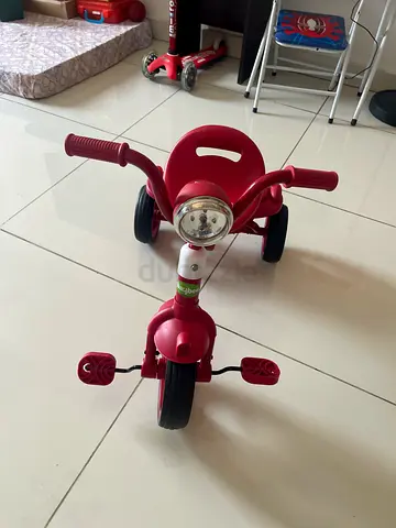 My red toddler tricycle with front light, seat and storage box- great condition