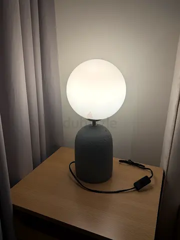 Modern bedside globe lamp with concrete-style base