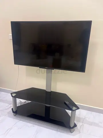 Phillips Flat-screen TV with glass TV stand - used