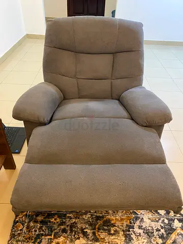 Gently used grey reclining and rocking armchair - comfortable single seater