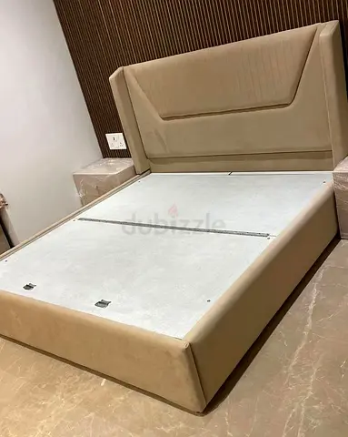 My beige upholstered bed frame with padded headboard