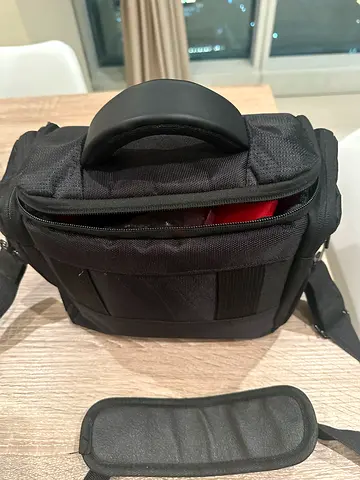 Nikon 7200 with 18 - 140 mm lens and Small black padded camera bag with shoulder strap